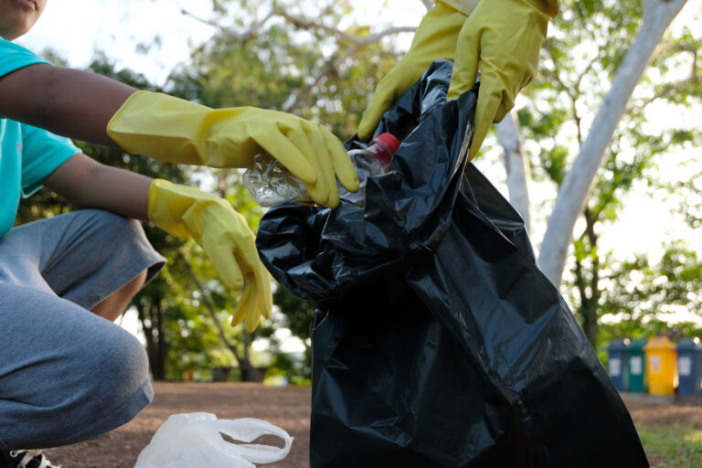 Group of kids volunteer help garbage collection charity environment, selective soft focus.
